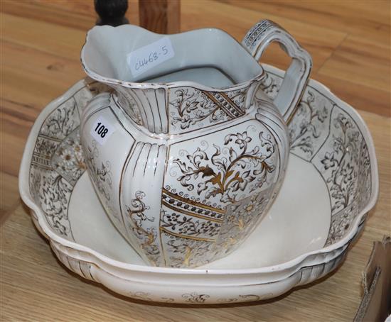 A gilt decorated jug and basin